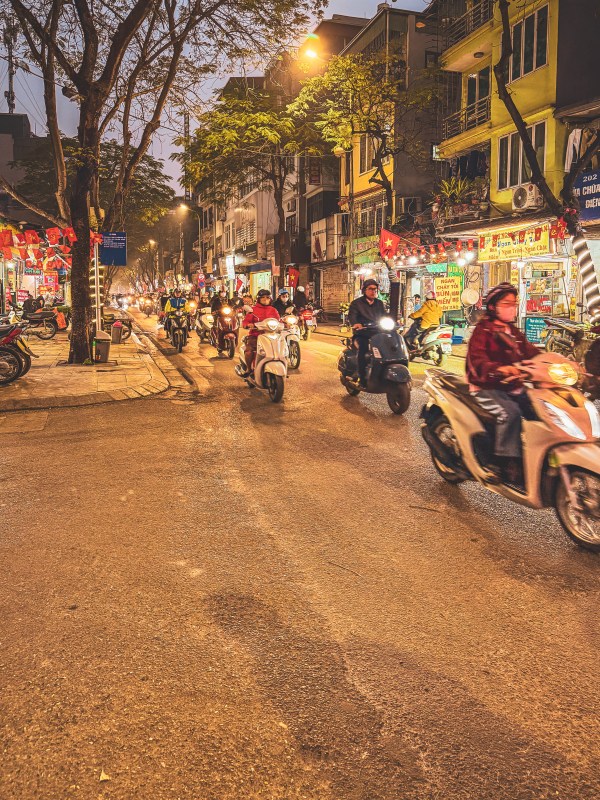 Motorbikes on a lively Hanoi street after dark.
