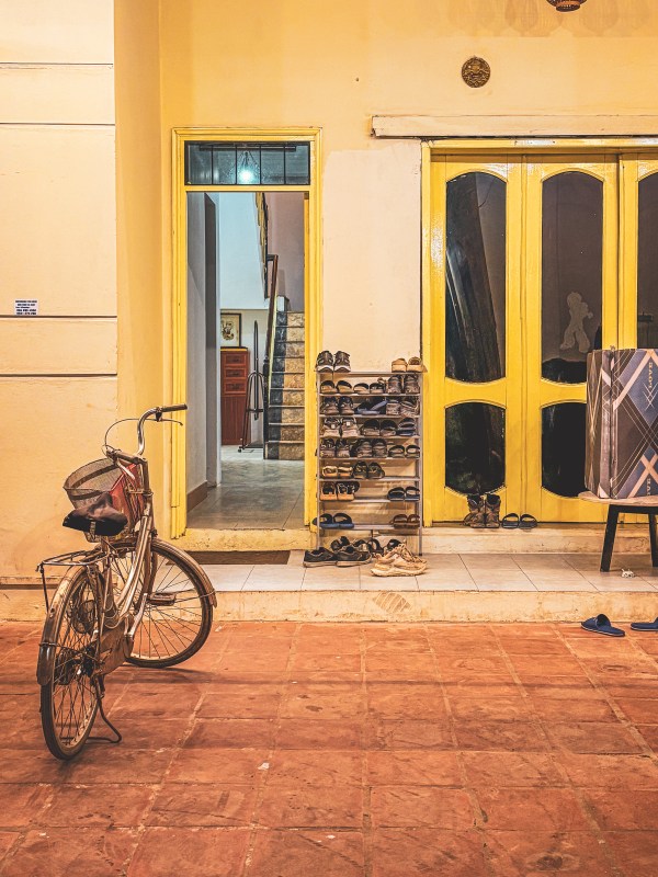 A bicycle outside a yellow building in Hanoi.