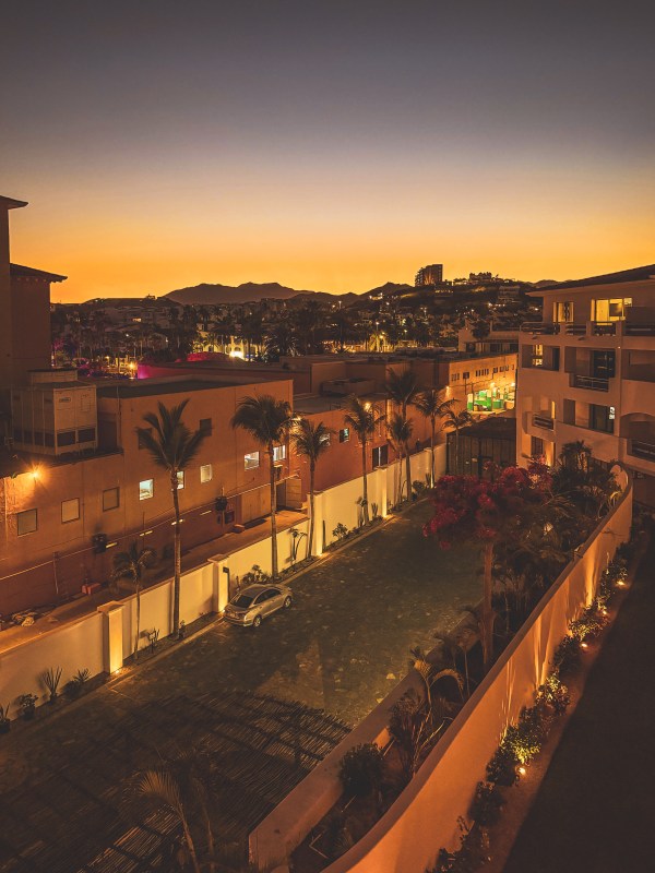 An elevated evening view across buildings and paths at a property.