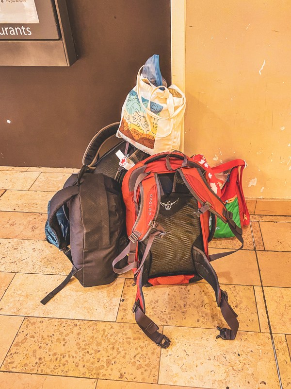 A packed backpack with personal items tucked into it.