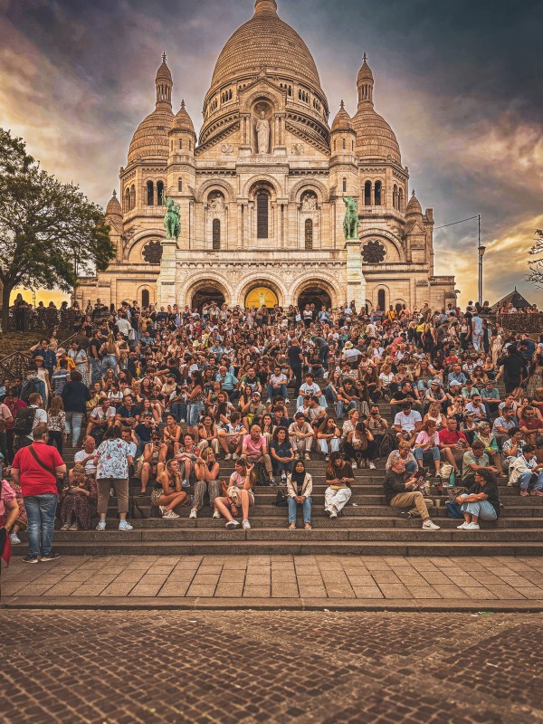 A crowd on the steps below Sacré-Cœur in Paris.