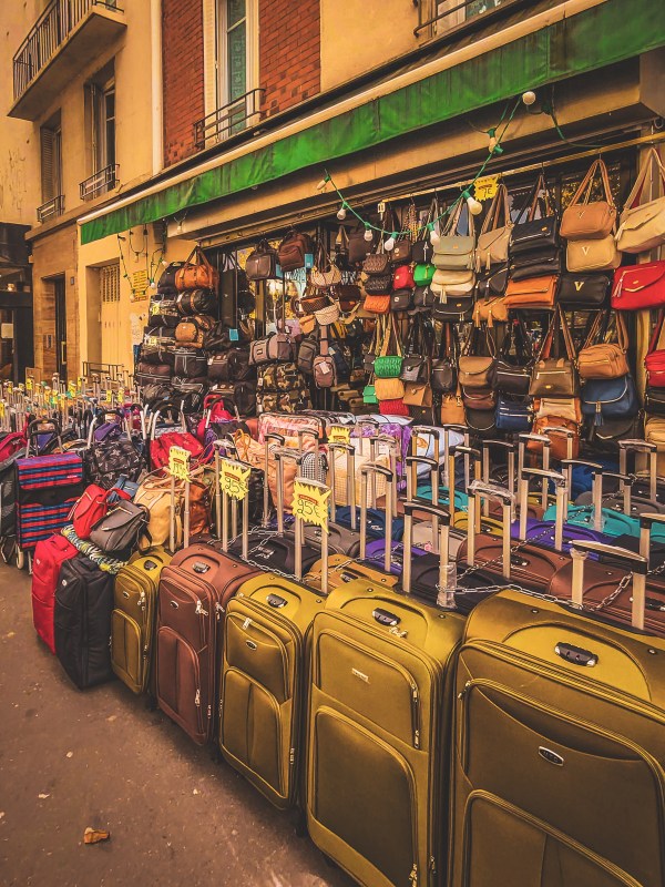 Suitcases and colourful handbags outside a Paris shop.