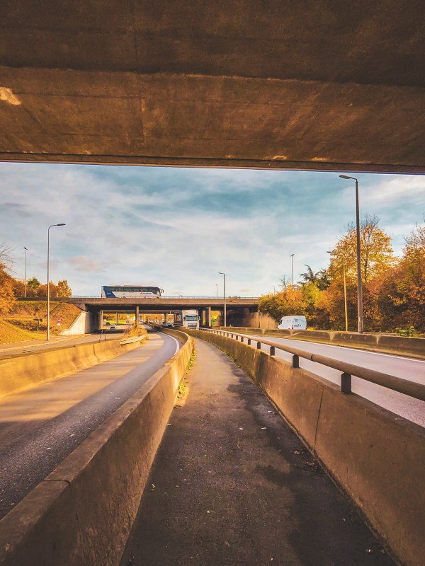 Pavement and road beneath an underpass in Roissy-en-France.