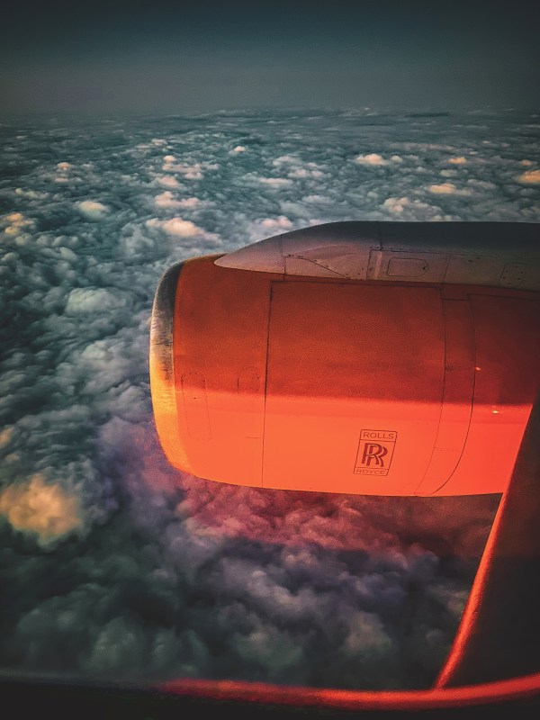 Aircraft engine above clouds at night.