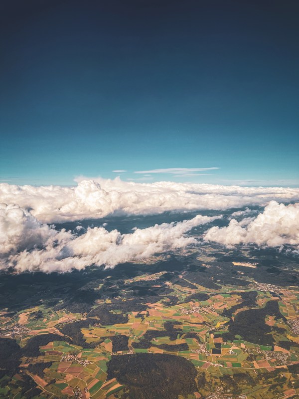 Fields and clouds viewed from an aircraft.