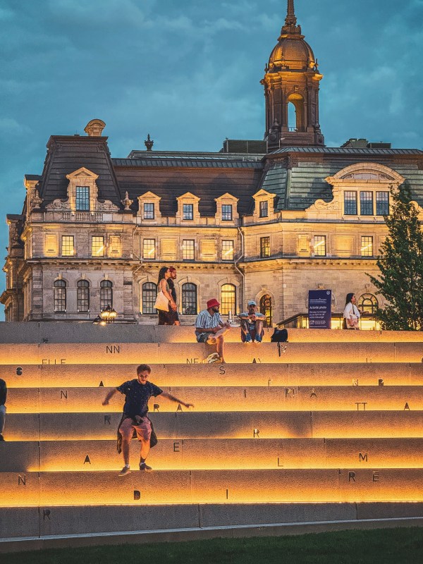 Historic civic building beyond illuminated steps.
