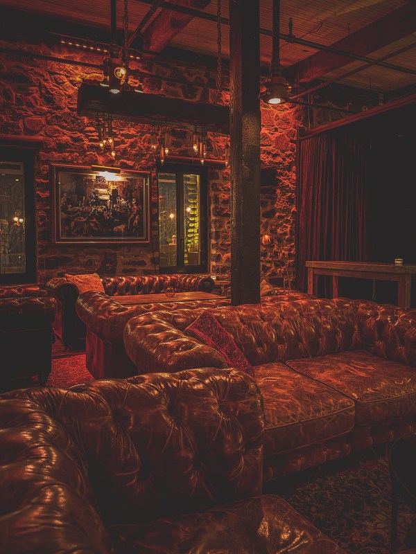 Warmly lit restaurant interior with upholstered seating.