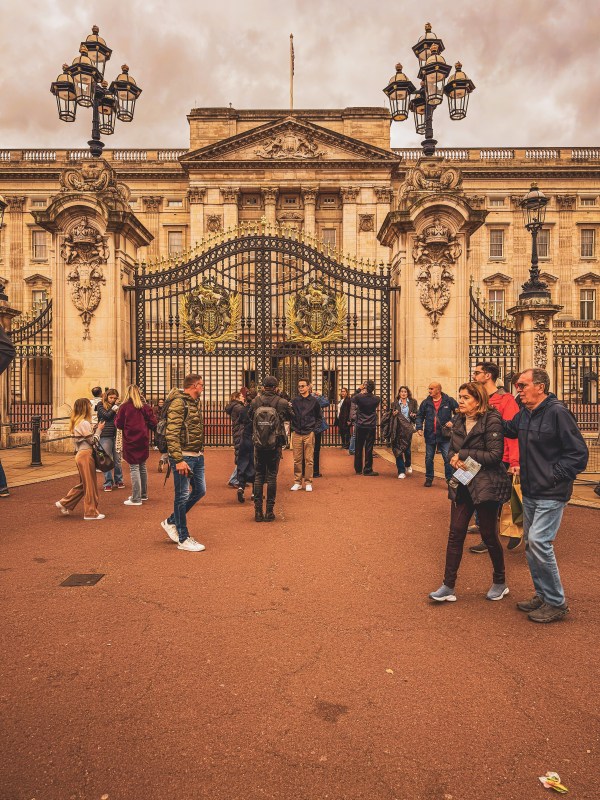 Visitors outside the ornate Buckingham Palace gates.